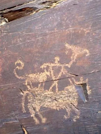 Saluki history, a rock carving of a mounted hunter with a falcon and a hound, Golpayegan, Iran
